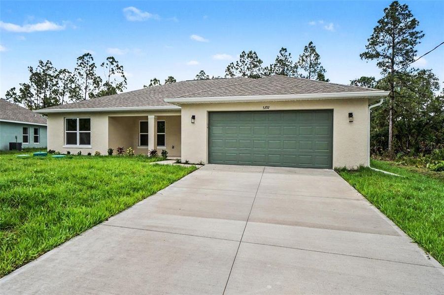 Front exterior of a new home in , North Port, FL, highlighting curb appeal (Image 2). Front exterior of a new home in , North Port, FL, highlighting curb appeal (Image 2).