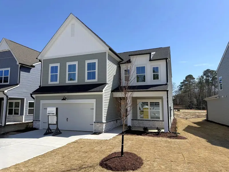 Front exterior of a new home in The Point, Rolesville, NC, highlighting curb appeal (Image 1). Front exterior of a new home in The Point, Rolesville, NC, highlighting curb appeal (Image 1).