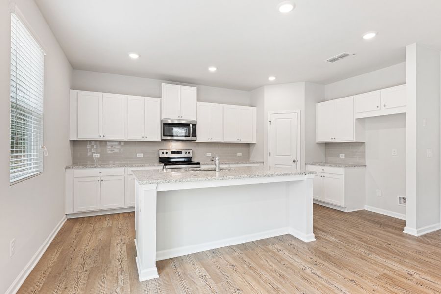 A kitchen with white cabinets. A kitchen with white cabinets.