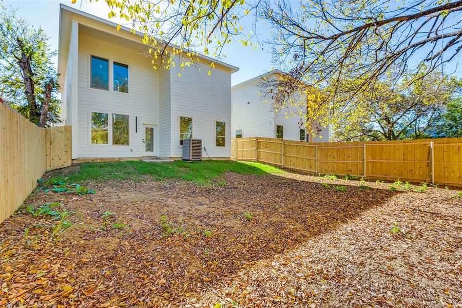 Rear view of property featuring central air condition unit