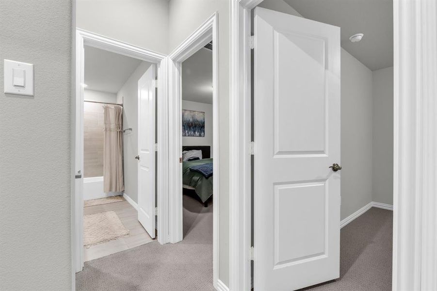 Corridor with light colored carpet