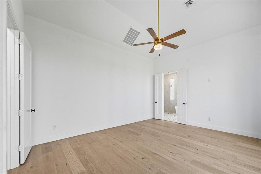 Empty room with light wood-type flooring and ceiling fan Empty room with light wood-type flooring and ceiling fan