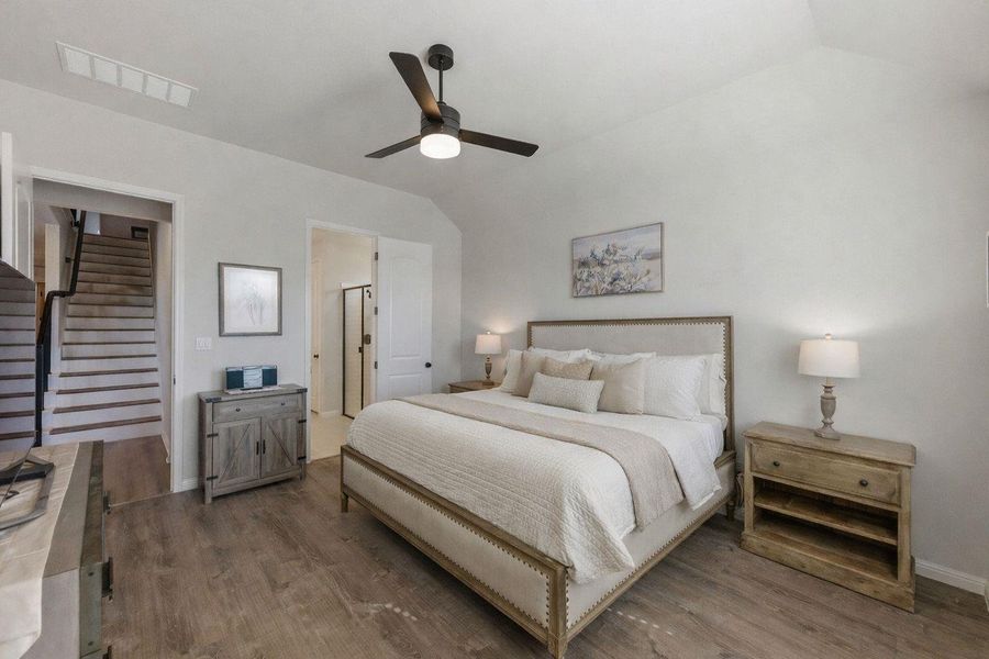 Bedroom featuring vaulted ceiling, ceiling fan, and wood finished floors