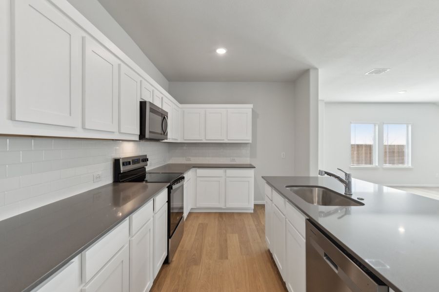 Kitchen in the Hayden home plan by Trophy Signature Homes – REPRESENTATIVE PHOTO