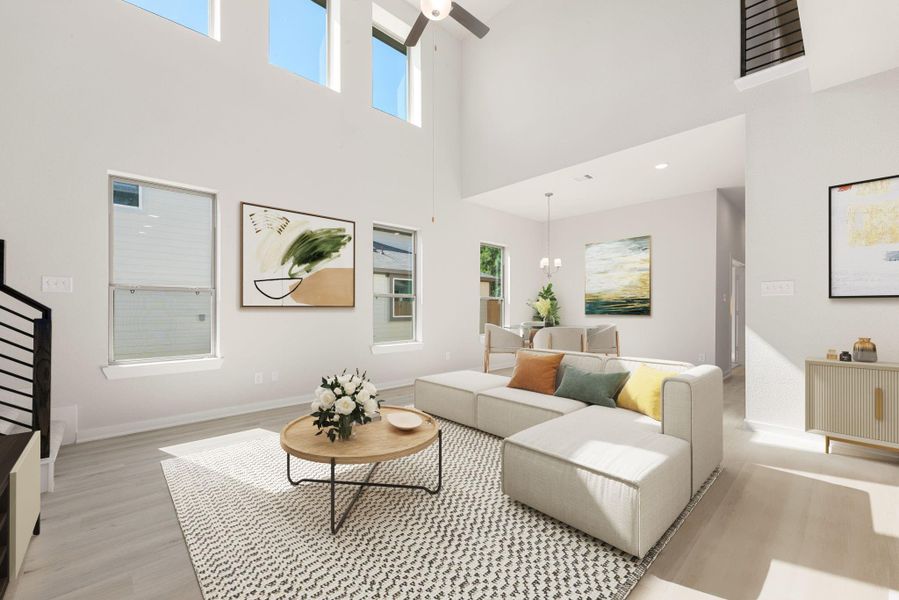 This stunning living area features soaring ceilings, expansive windows that fill the space with natural light, and elegant light-toned flooring. The open layout seamlessly connects the living and dining areas, creating an inviting atmosphere perfect for gatherings or relaxing in style.