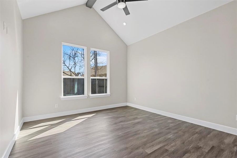 Unfurnished room with high vaulted ceiling, hardwood / wood-style floors, ceiling fan, and beam ceiling