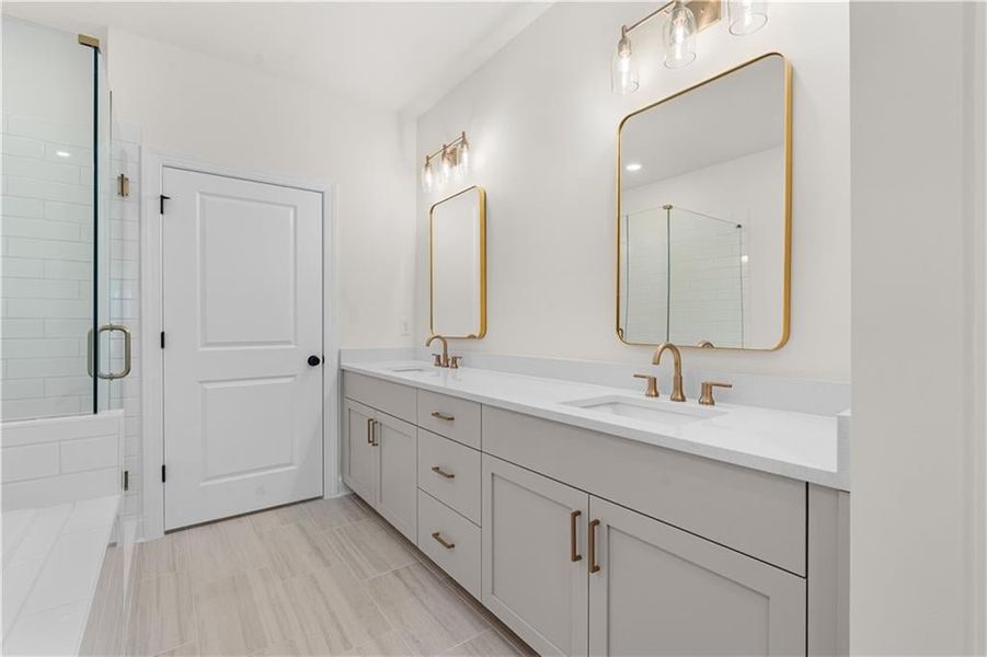 Full bathroom with a shower stall and double vanity