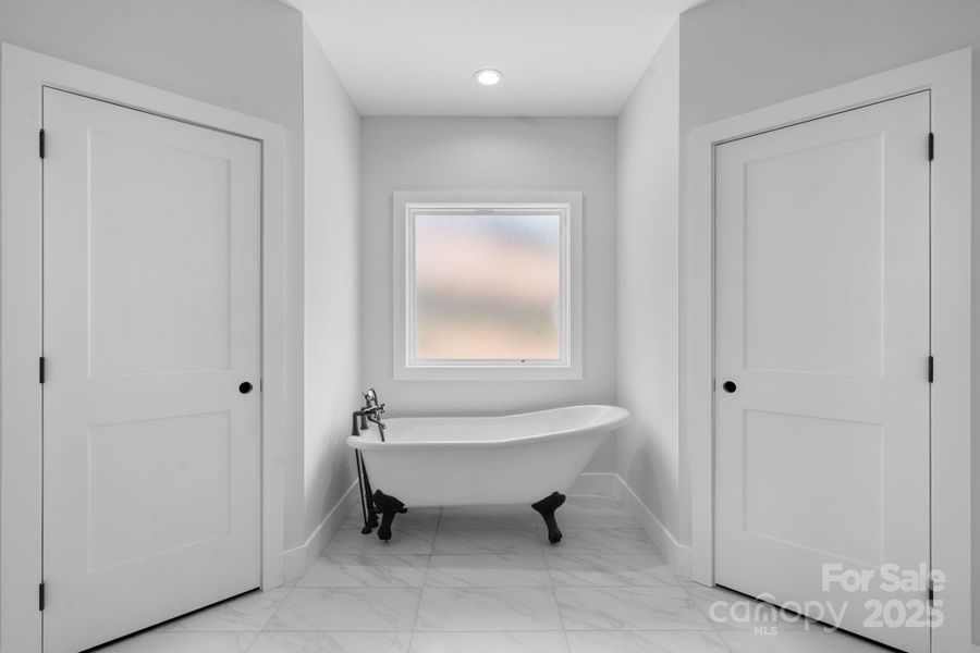 master with soak tub and his/her walk-in closets