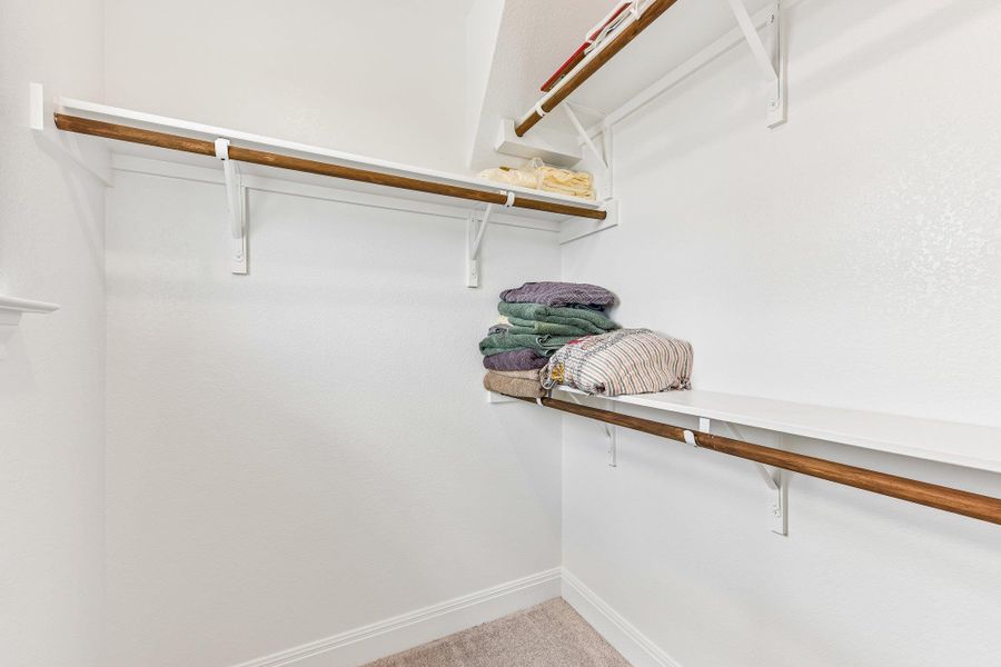 Ample closet space with shelving and hanging rods to organize your wardrobe.