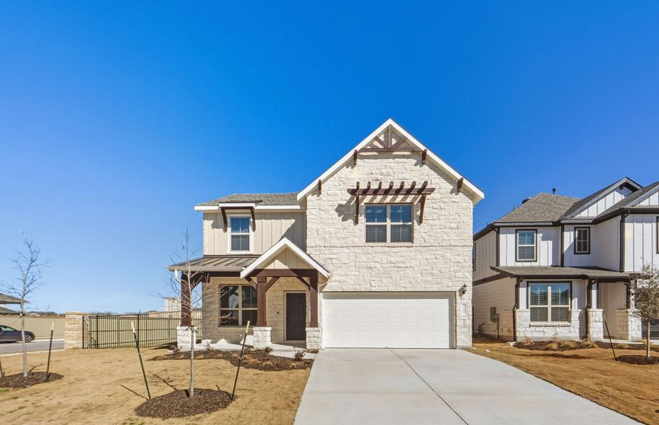 Front exterior of a new home in Santa Rita Ranch, Liberty Hill, TX, highlighting curb appeal (Image 24).
