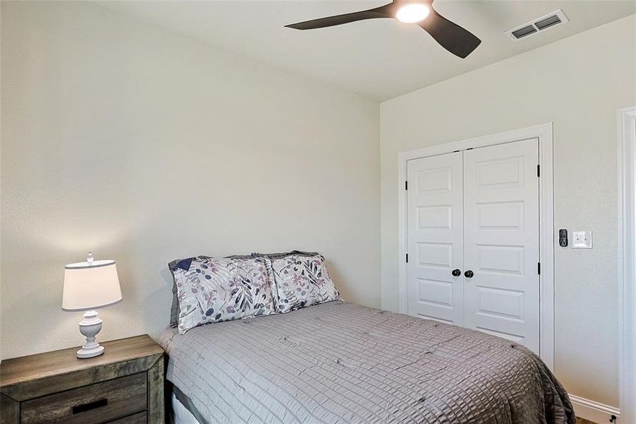 Recessed paneled closet doors, a contemporary ceiling fan with integrated lighting, and neutral wall tones