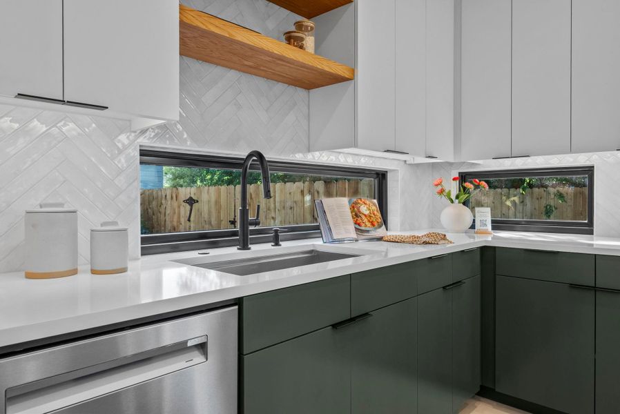 Kitchen with stainless steel dishwasher, decorative backsplash, healthy amount of natural light, and modern cabinets Kitchen with stainless steel dishwasher, decorative backsplash, healthy amount of natural light, and modern cabinets