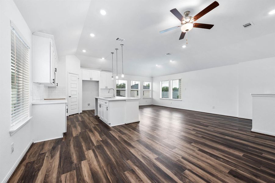 View from the living space into the open kitchen and formal dining. View from the living space into the open kitchen and formal dining.