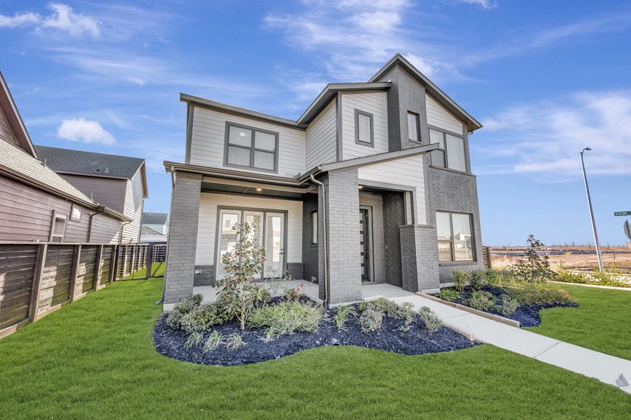 Front exterior of a new home in Indigo - Enclave Collection, Richmond, TX, highlighting curb appeal (Image 2). Front exterior of a new home in Indigo - Enclave Collection, Richmond, TX, highlighting curb appeal (Image 2).