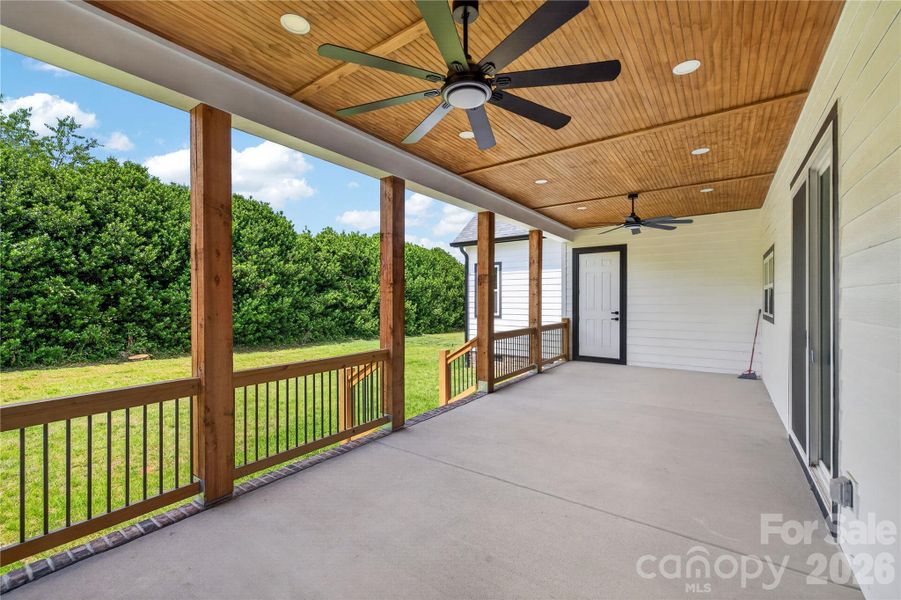This back porch was made for slow mornings, coffee in hand, and nights outside with family and friends. The wood ceiling, oversized fans, and peaceful backyard views make it feel like your own private getaway