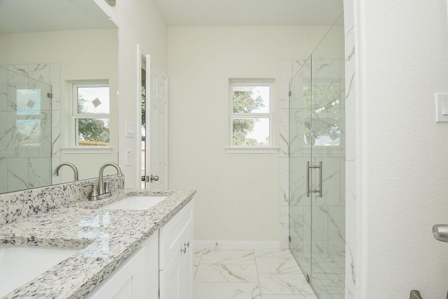 This is a bright, empty room with neutral walls, plush carpeting, and a ceiling fan with lighting. There are two doors, indicating potential closet space and entry/exit points. This is a bright, empty room with neutral walls, plush carpeting, and a ceiling fan with lighting. There are two doors, indicating potential closet space and entry/exit points.