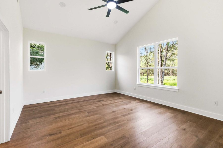 Lofty ceilings and rich hardwood flooring define this inviting, naturally illuminated bedroom. Lofty ceilings and rich hardwood flooring define this inviting, naturally illuminated bedroom.