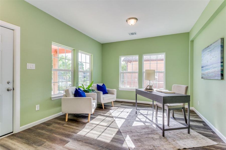 Office area with light hardwood / wood-style floors