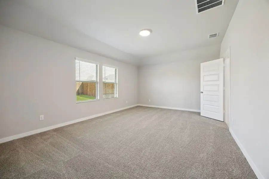 Primary Suite in the Oscar home plan by Trophy Signature Homes – REPRESENTATIVE PHOTO