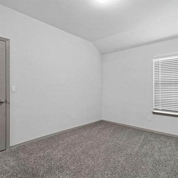 One of three spacious secondary bedrooms featuring lush carpets, large window and tall ceiling. **This image is from another Saratoga Home with similar floor plan - Myrtle Floorplan.**