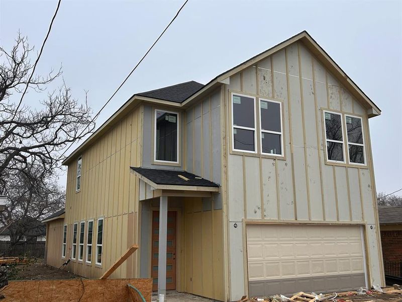 View of front facade featuring a garage