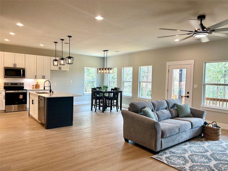 Open concept kitchen, dining, and living areas. Open concept kitchen, dining, and living areas.