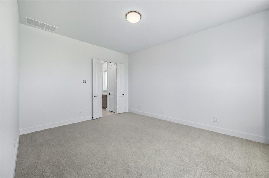 Carpeted empty room with baseboards Carpeted empty room with baseboards