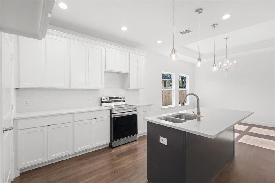 Kitchen with white cabinets, stainless steel electric stove, and sink