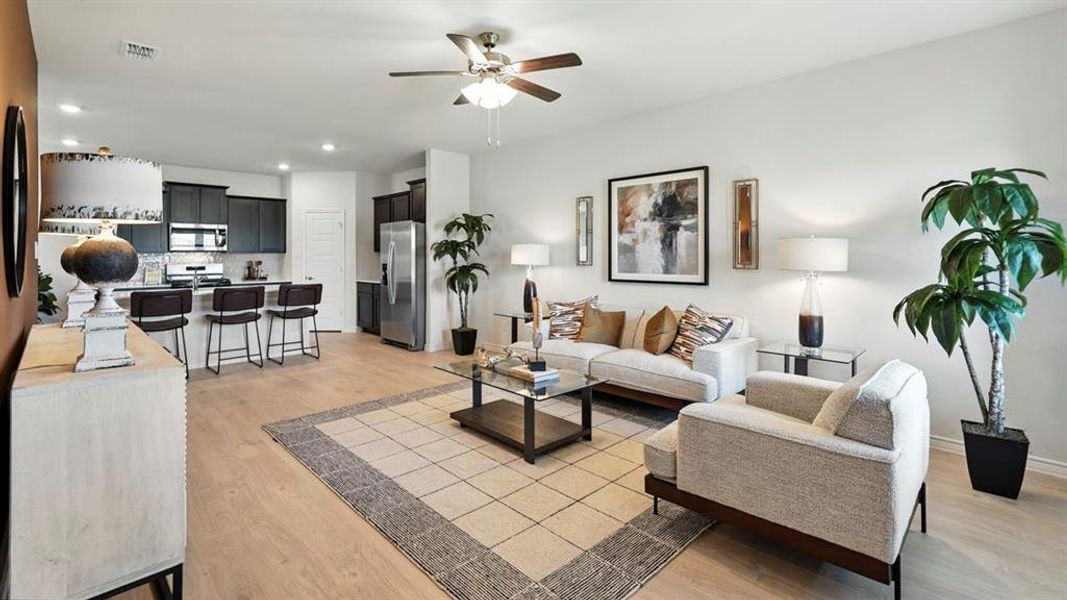 Living area with light wood-style floors, recessed lighting, and a ceiling fan Living area with light wood-style floors, recessed lighting, and a ceiling fan