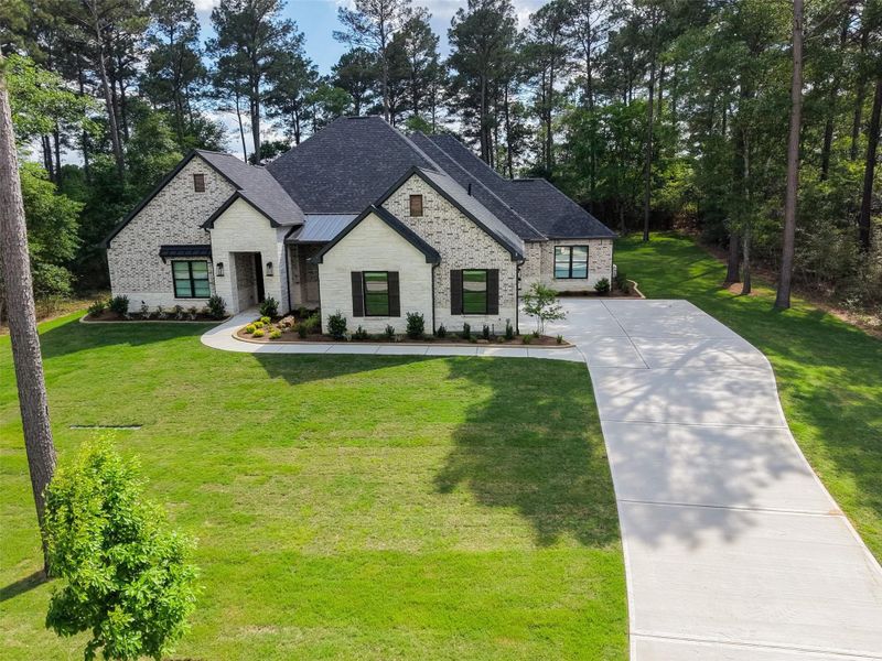 Front exterior of a new home in , Plantersville, TX, highlighting curb appeal (Image 21).