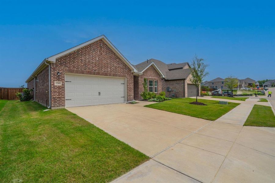Front exterior of a new home in Devonshire, Forney, TX, highlighting curb appeal (Image 2). Front exterior of a new home in Devonshire, Forney, TX, highlighting curb appeal (Image 2).