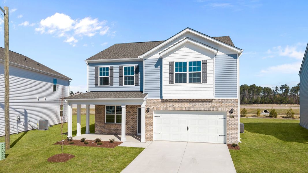Front exterior of a new home in Ridgewood Farms, Winterville, NC, highlighting curb appeal (Image 13).