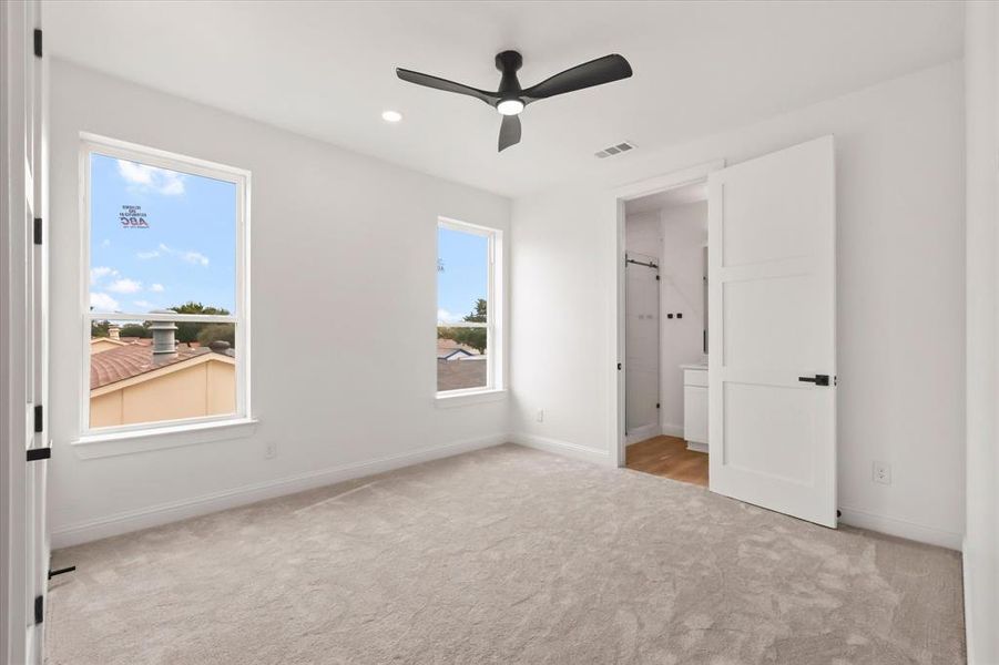 Unfurnished bedroom featuring light carpet, recessed lighting, and a ceiling fan Unfurnished bedroom featuring light carpet, recessed lighting, and a ceiling fan