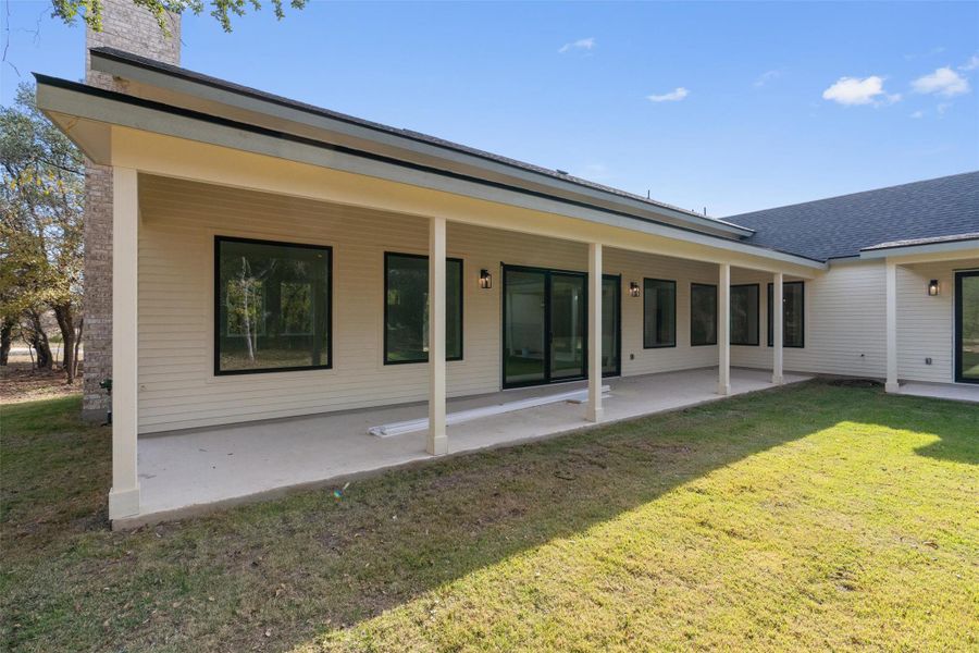 Rear view of property with a yard, a patio, and a chimney Rear view of property with a yard, a patio, and a chimney