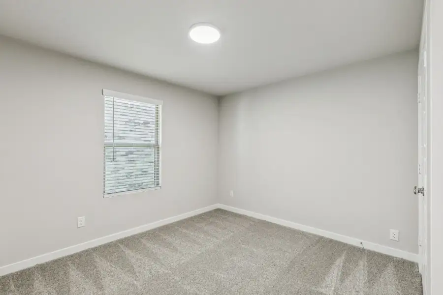 Bedroom in the Harper home plan by Trophy Signature Homes – REPRESENTATIVE PHOTO