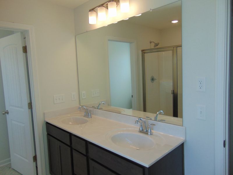 The primary bathroom has a soak in tub and shower, as well as two sinks.
