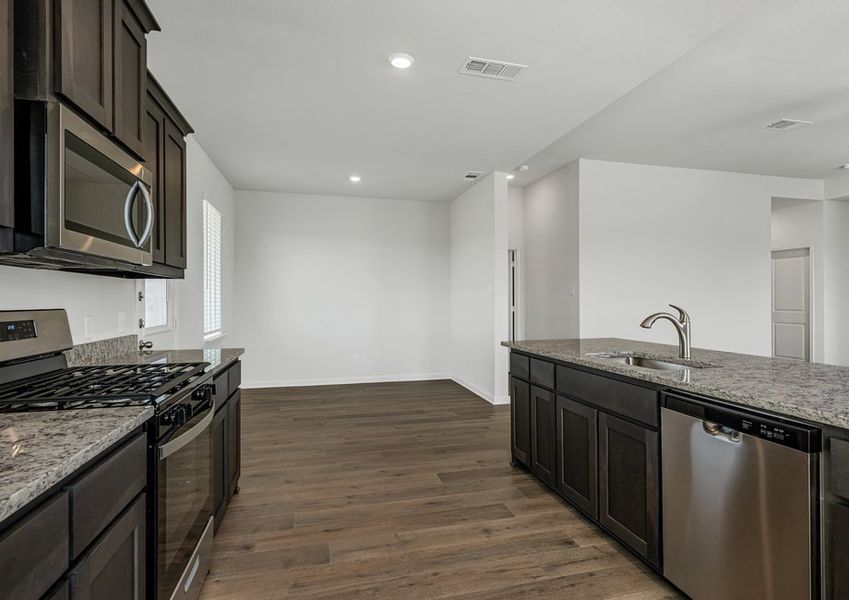 The dining room sits adjacent to the kitchen. The dining room sits adjacent to the kitchen.