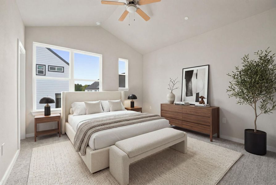 Vaulted ceilings and generous windows create an airy atmosphere in this peaceful bedroom.