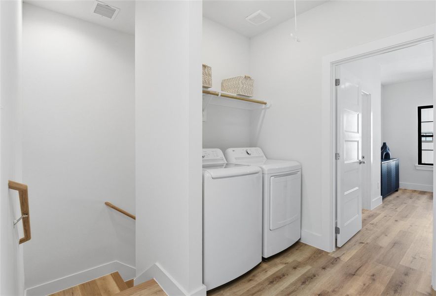 A bright, modern laundry area with a washer and dryer set.