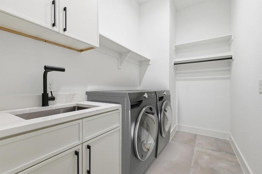 Washroom featuring cabinet space, independent washer and dryer, and light tile patterned floors Washroom featuring cabinet space, independent washer and dryer, and light tile patterned floors