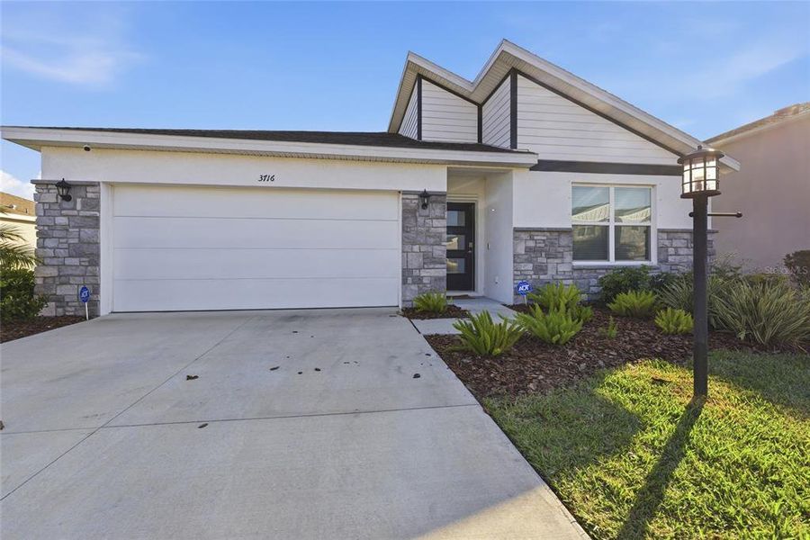 Front exterior of a new home in , Bradenton, FL, highlighting curb appeal (Image 28).