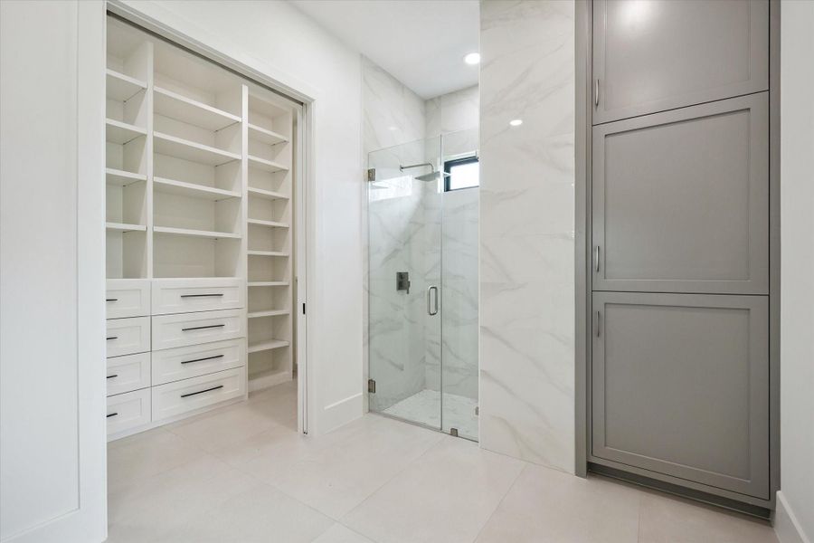 Guest bath with walk-in closet, glass shower, and tall linen tower. Guest bath with walk-in closet, glass shower, and tall linen tower.