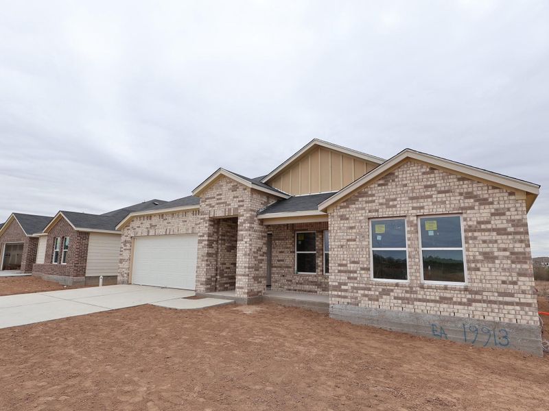 Front exterior of a new home in Carillon, Manor, TX, highlighting curb appeal (Image 10).