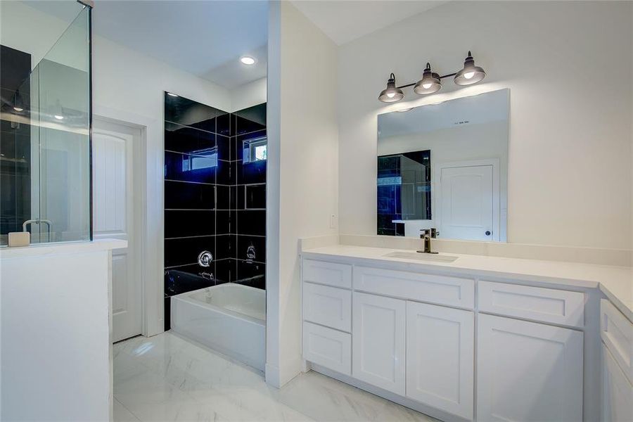 Full bath with vanity, an enclosed shower, a bath, light marble finish flooring, and recessed lighting Full bath with vanity, an enclosed shower, a bath, light marble finish flooring, and recessed lighting