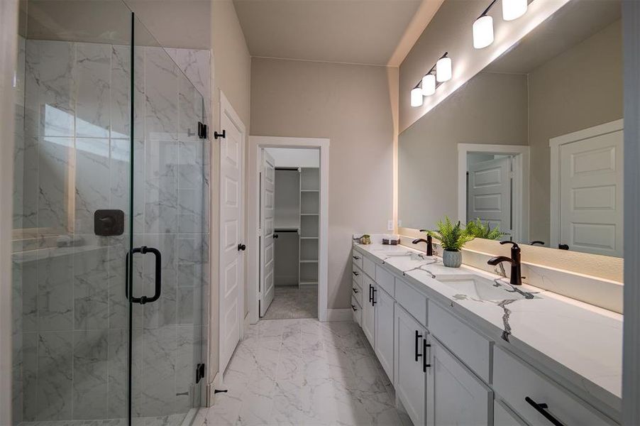 Bathroom featuring an enclosed shower and vanity