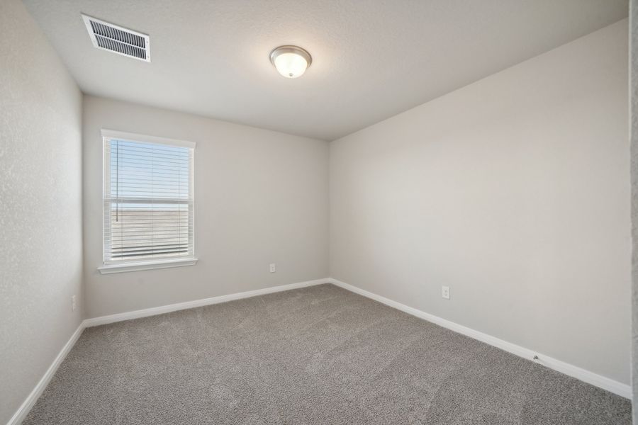 Guest bedroom in the Matador floorplan in the Meritage Homes community.