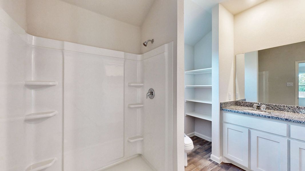 A bathroom with a glass shower. A bathroom with a glass shower.