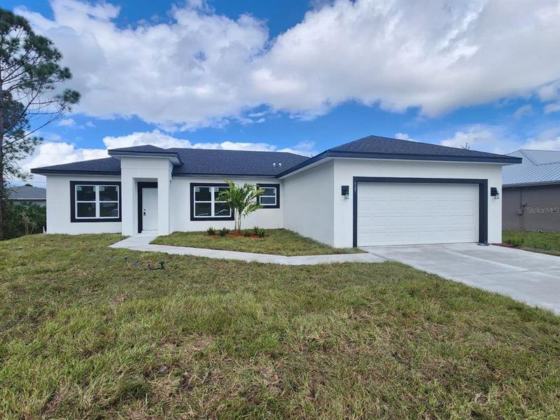 Front exterior of a new home in , Palm Bay, FL, highlighting curb appeal (Image 24). Front exterior of a new home in , Palm Bay, FL, highlighting curb appeal (Image 24).