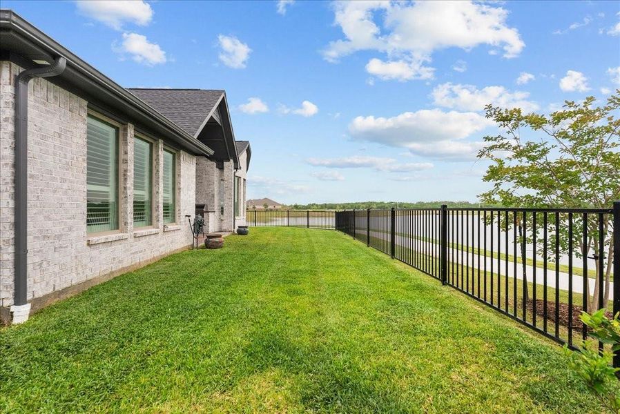 Step outside to enjoy the covered patio and expansive backyard overlooking the water — the perfect place to relax and unwind.