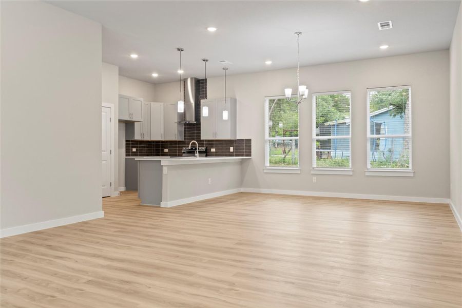 Spacious view of a stunning dining and living area, bathed in natural light—perfect for making it your new home! Spacious view of a stunning dining and living area, bathed in natural light—perfect for making it your new home!